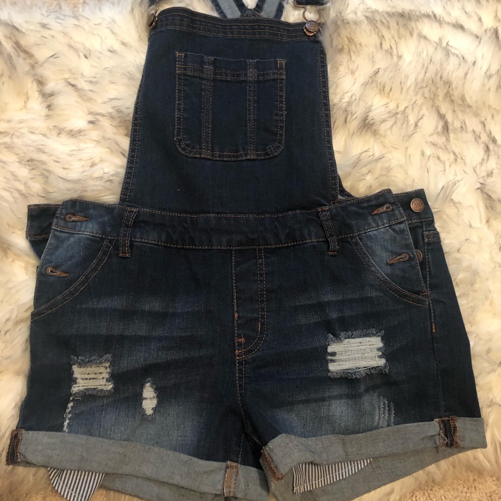 Dark wash overall shorts.